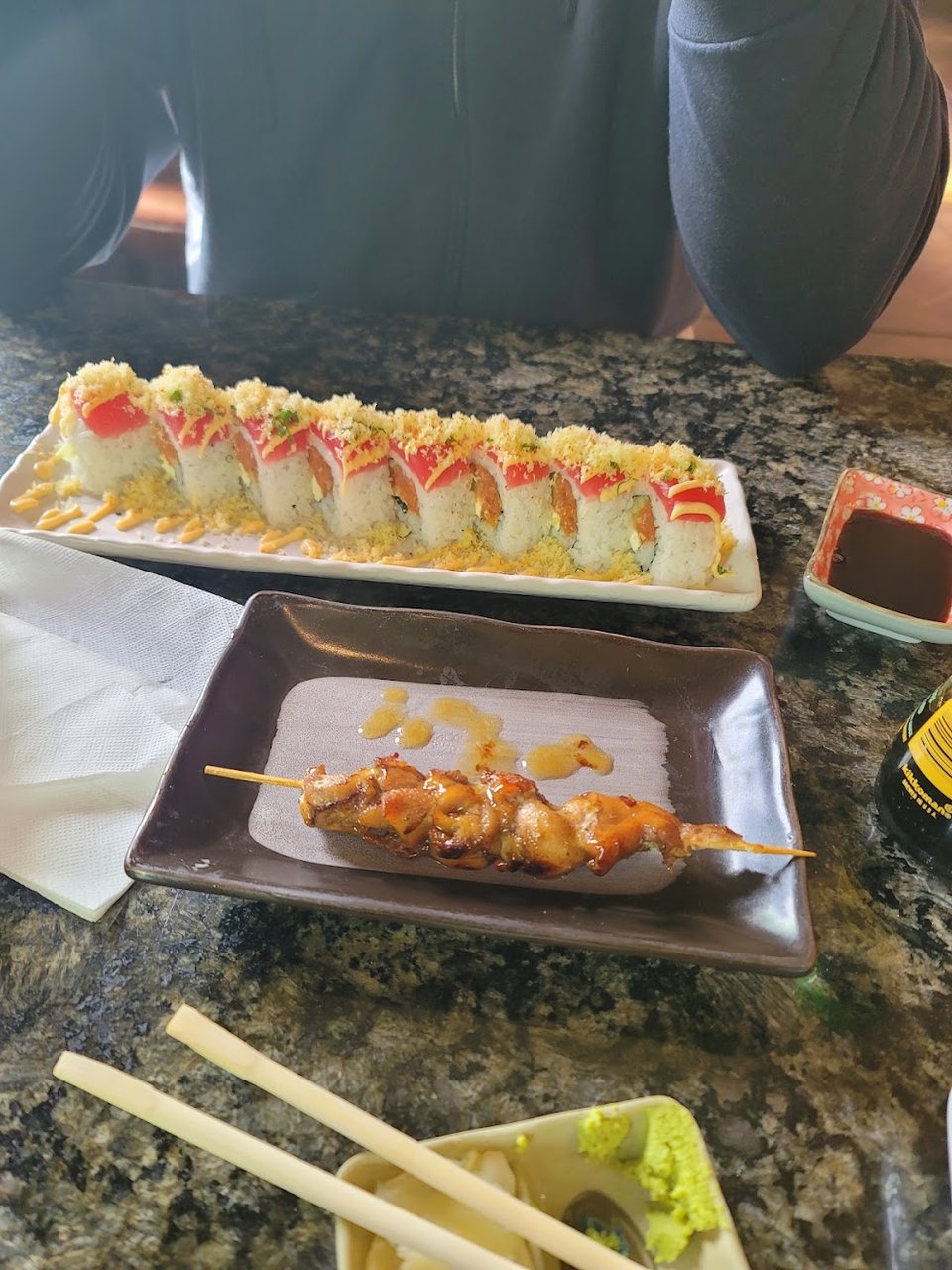 Printed menu with ramen, rolls, and bento boxes.